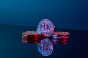 Photo of Bitcoins Illuminated by a Purple Light