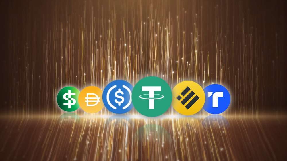 kenson Investments | Future Market Trends: The Rise of Real-World Asset Tokenization and Global Digital Asset Adoption Icons of various stablecoins displayed on a glowing background.