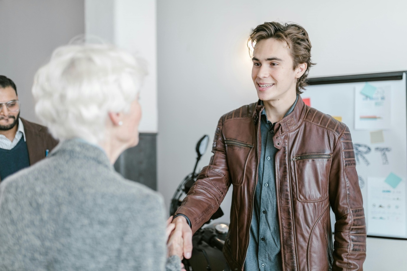 a man shaking hands with a woman