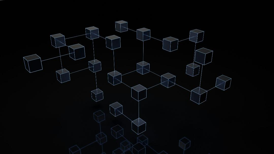 A 3D-rendered image of a network of interconnected cubes against a dark background, representing a blockchain network.