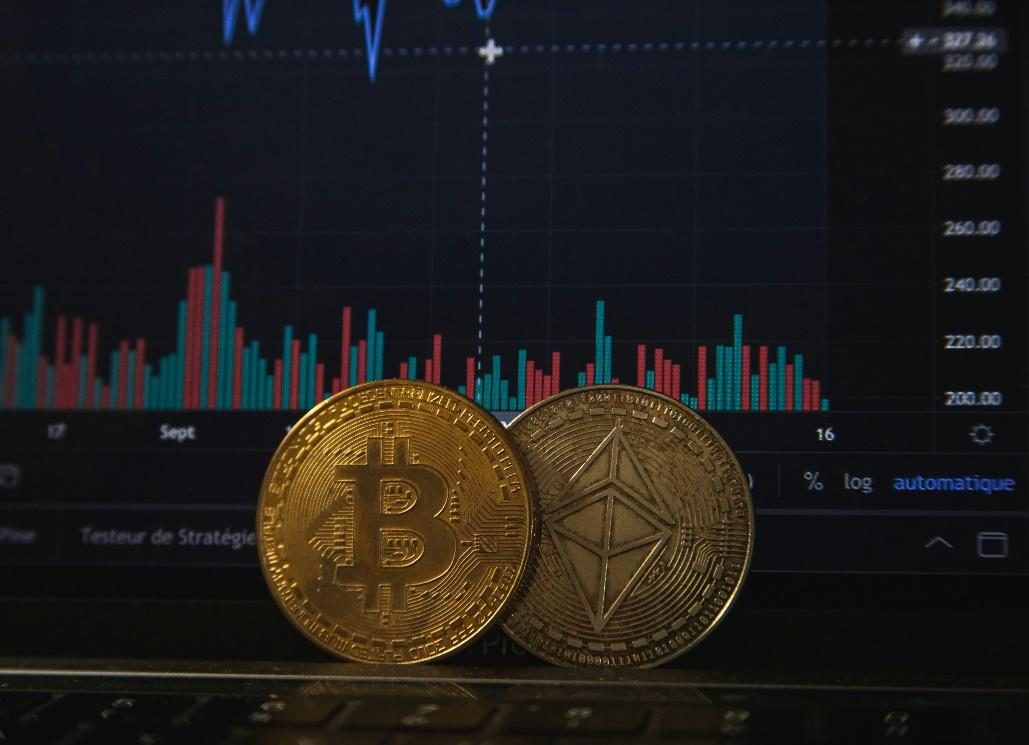A close-up shot of a gold Bitcoin and a silver Ethereum coin.