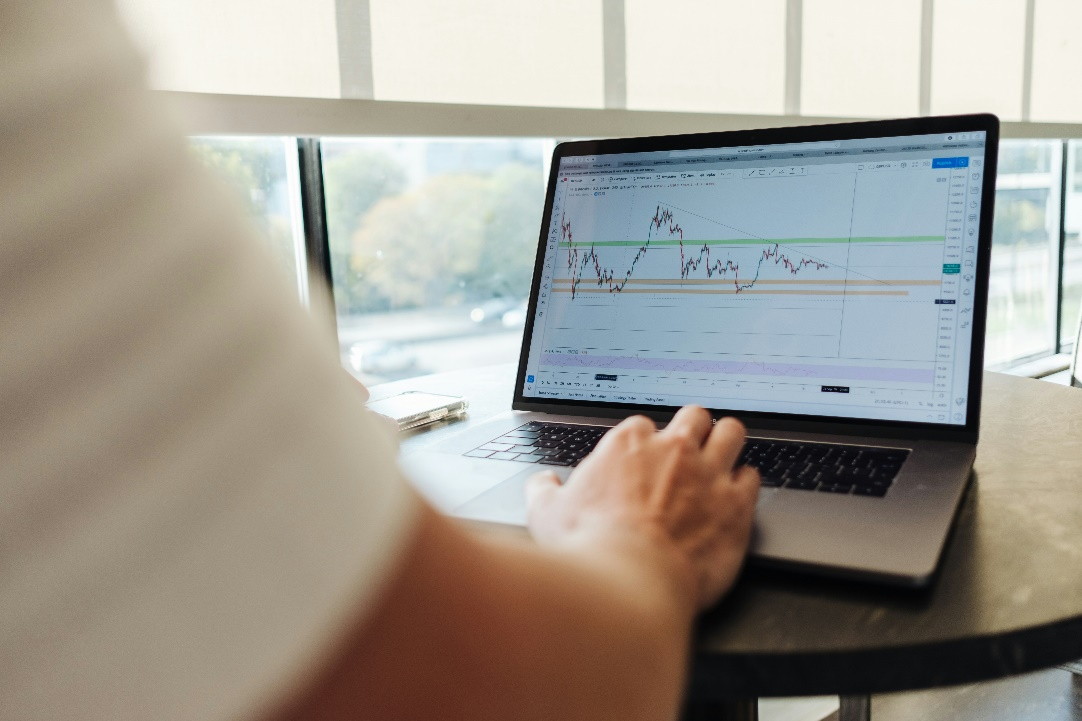 A person analyzing cryptocurrency stock prices on a computer screen.