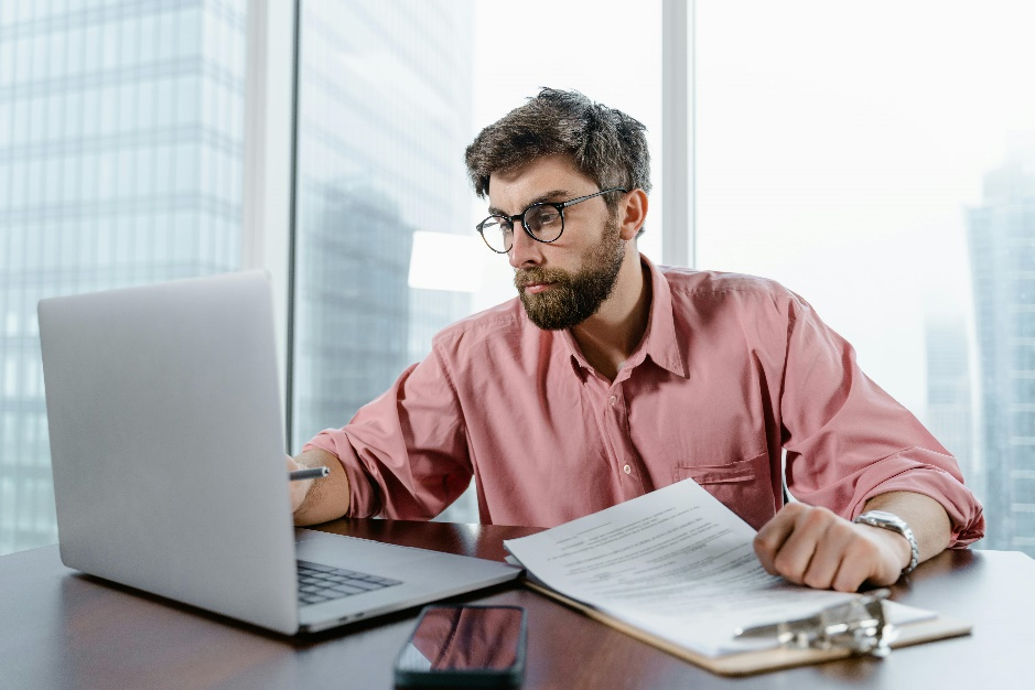 Professional man using a laptop to research digital asset regulations, reflecting the growing interest in blockchain compliance.