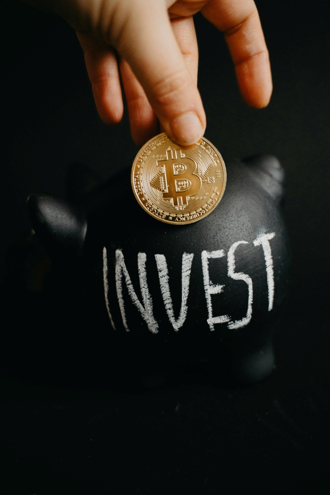 A person holding a coin, symbolizing individual engagement with digital assets amid institutional crypto adoption.