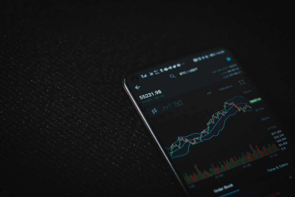 Black smartphone on dark fabric surface.