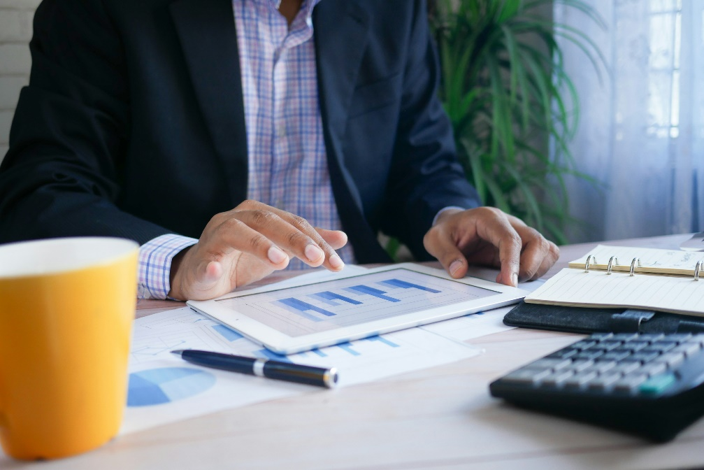 Professional holding a tablet reviewing digital asset regulations and stablecoin policies.