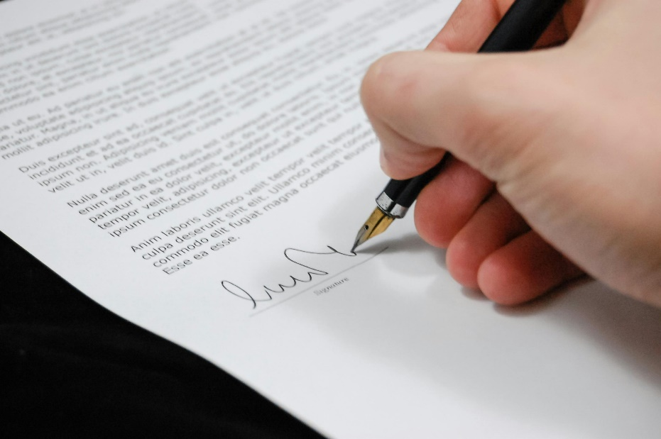 Signing official compliance paperwork for regulatory enforcement