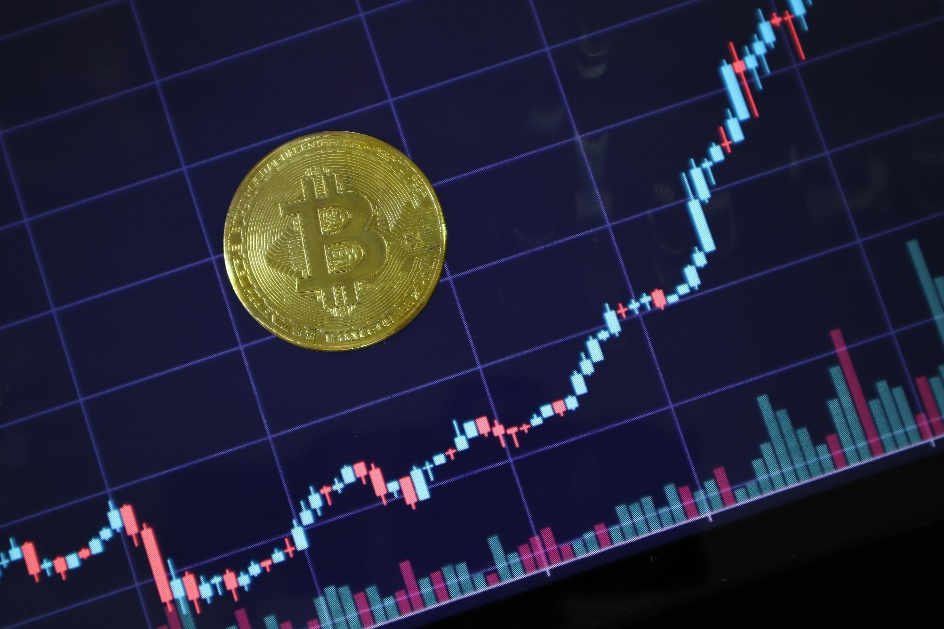Bitcoin token beside financial chart showing asset growth