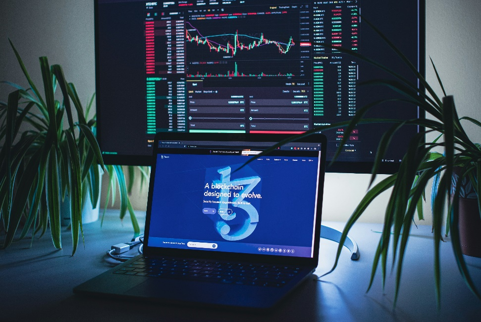 A monitor with cryptocurrency trading charts and data.