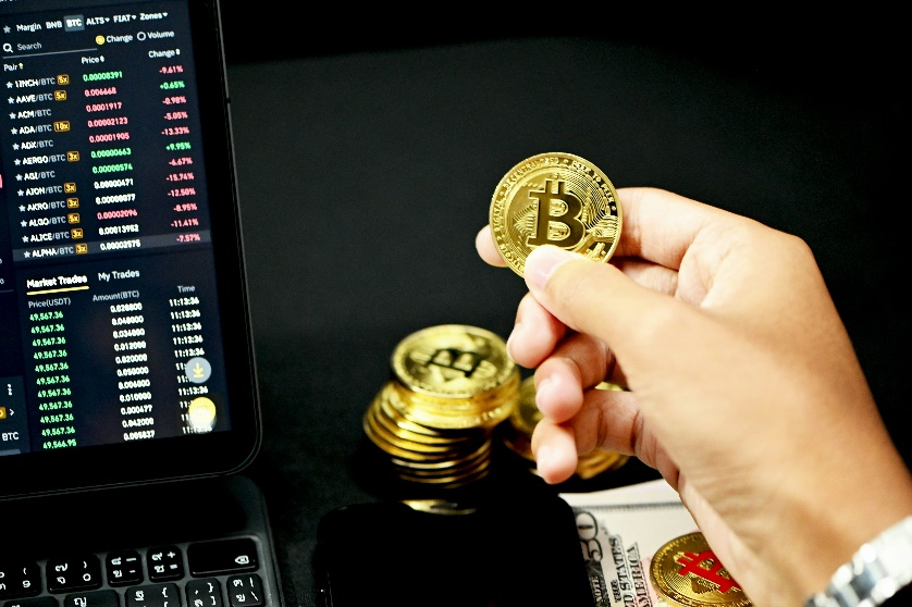 Hand holding gold coin symbolizing tokenized asset