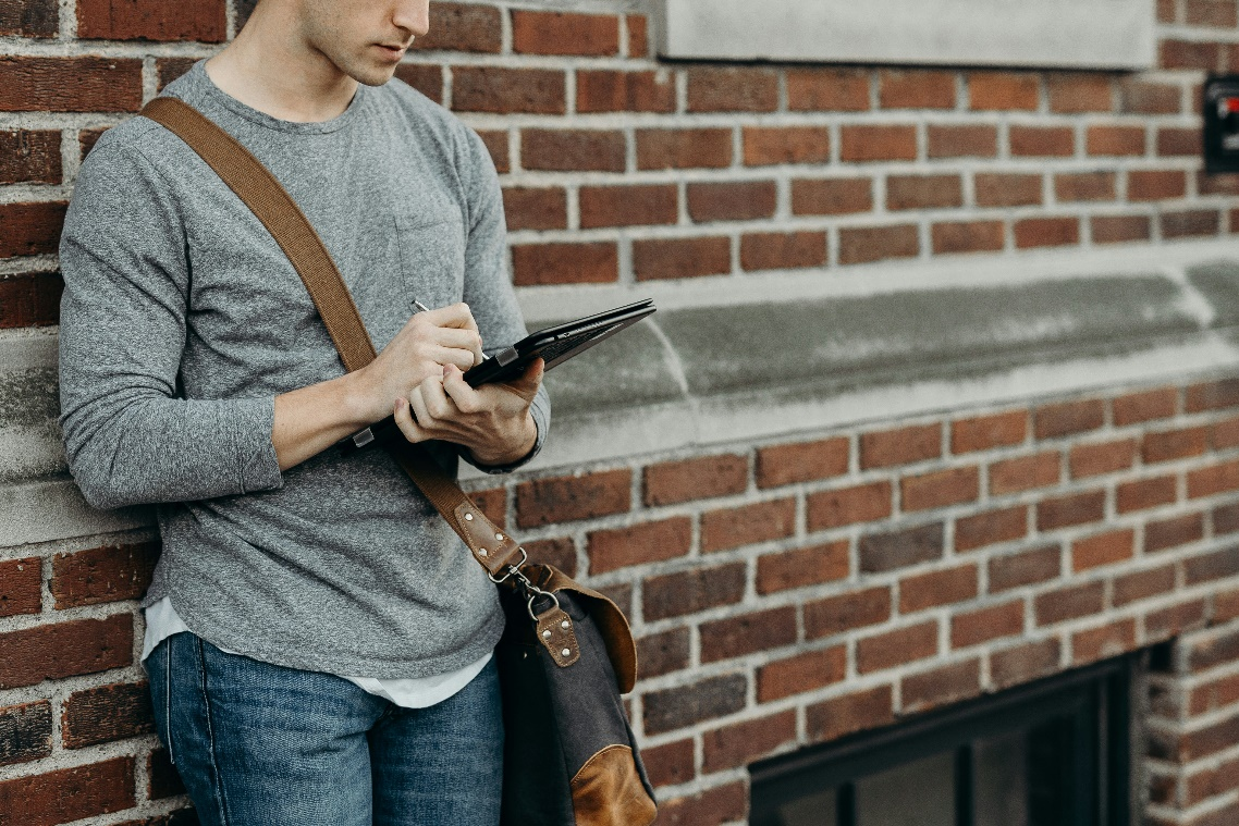 Person holding a tablet with tokenized voting interface