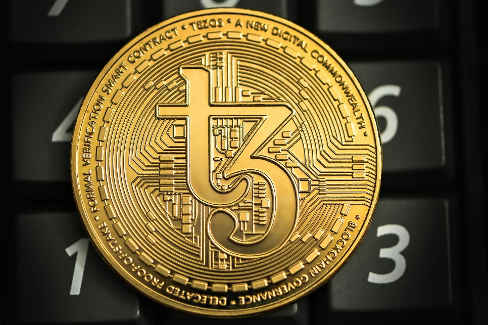 A golden Tezos (XTZ) cryptocurrency coin.