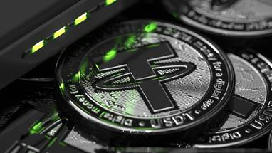 A close-up of several physical Tether (USDT) cryptocurrency coins