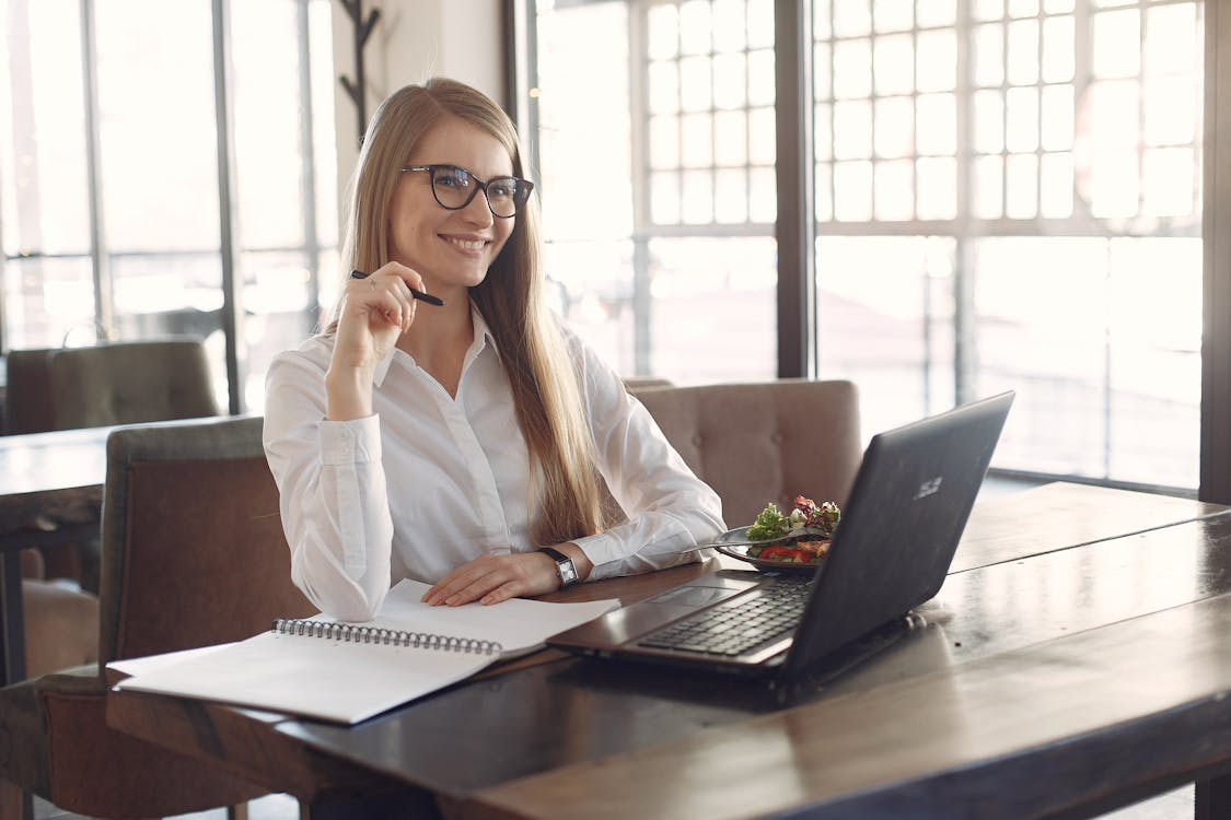 Woman reviewing blockchain and crypto market trends on a laptop, illustrating informed participation in digital assets.