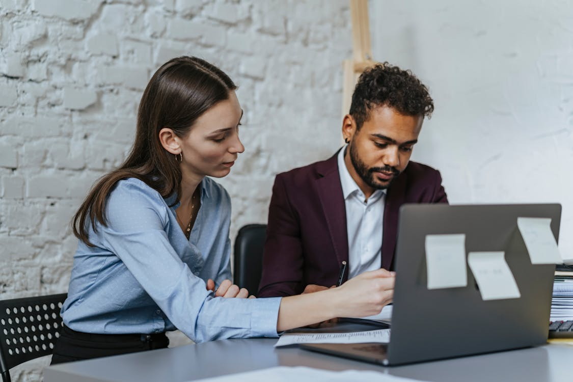 Digital asset consultant reviewing cryptocurrency charts and blockchain insights with a client, guiding informed decision-making.