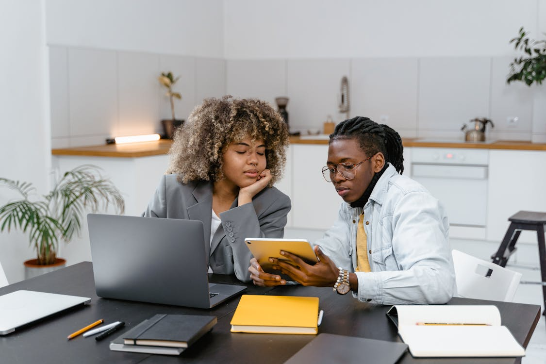 Man and woman reviewing digital asset insights on a tablet