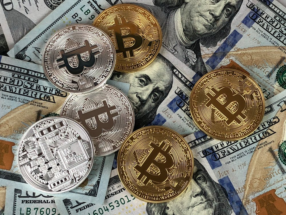 Round silver and gold cryptocurrency coins representing digital assets in the modern economy.