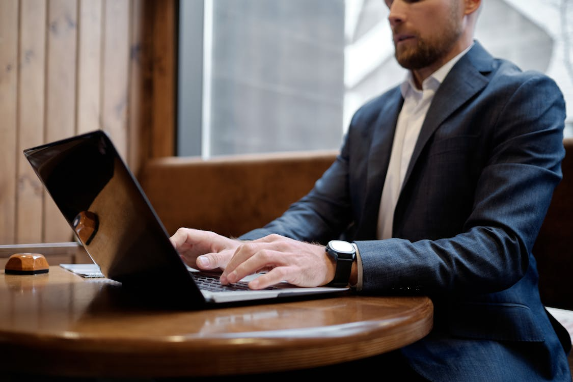 kenson Investments | Cryptocurrency: The Modern Path to Financial Freedom – Rethinking Wealth Creation Digital asset management consultant analyzing cryptocurrency strategies on laptop and tablet.