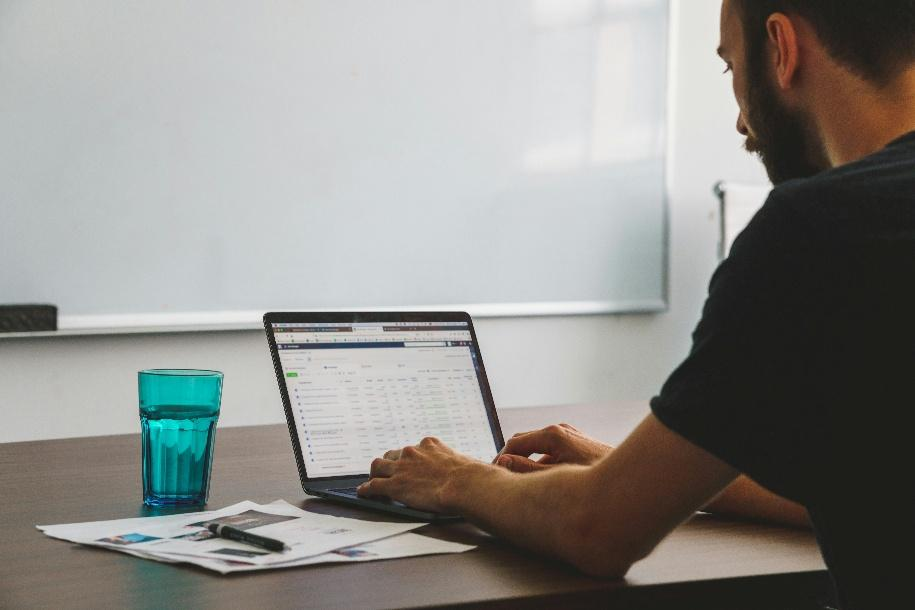  Analyst reviewing blockchain transaction data and network activity on a laptop.